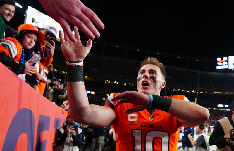 Dec 14, 2025; Denver, Colorado, USA; Denver Broncos quarterback Bo Nix (10) high-fives fans after defeating the Green Bay Packers at Empower Field at Mile High. Mandatory Credit: Ron Chenoy-Imagn Images