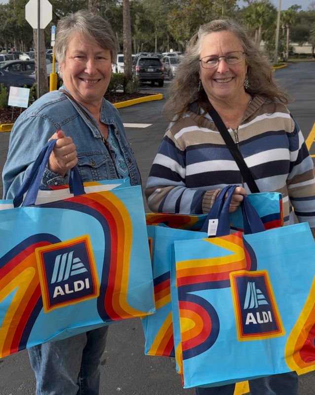 Sophia Granger, left, of Deltona and her sister Tina Kamp of DeLand hold up their Aldi bags after shopping at the new Aldi discount grocery store at 353 W. Granada Blvd. in Ormond Beach on opening day, Thursday, Dec. 18, 2025.