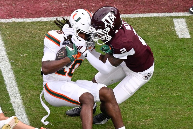 Dec 20, 2025; College Station, TX, USA; Texas A&M Aggies cornerback Dezz Ricks (2) brings down Miami Hurricanes wide receiver Malachi Toney (10) during first quarter of the first round game of the CFP National Playoff at Kyle Field. Mandatory Credit: Jerome Miron-Imagn Images