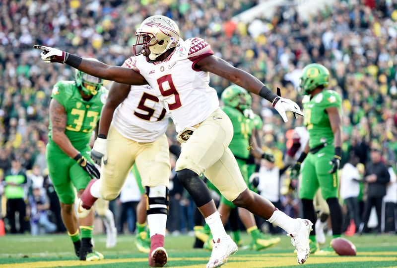 Jan 1, 2015; Pasadena, CA, USA; Florida State Seminoles running back Karlos Williams (9) celebrates making a touchdown against the Oregon Ducks during the first half in the 2015 Rose Bowl college football game at Rose Bowl. Mandatory Credit: Gary Vasquez-USA TODAY Sports