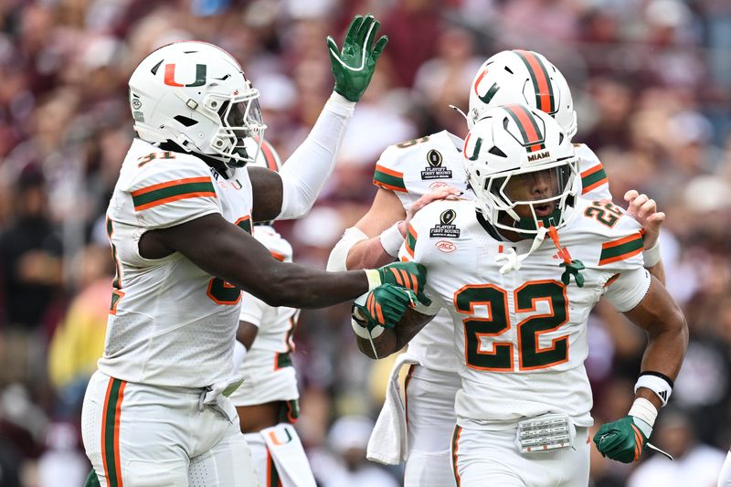 Dec 20, 2025; College Station, TX, USA; Miami Hurricanes running back Girard Pringle Jr. (22) celebrates a hit on the Texas A&M Aggies during first half of the first round game of the CFP National Playoff at Kyle Field. Mandatory Credit: Maria Lysaker-Imagn Images