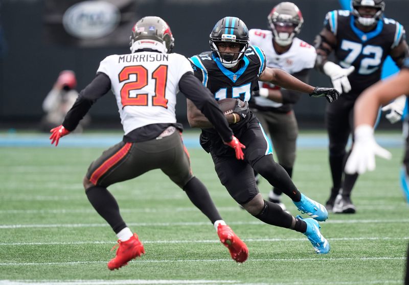 Dec 21, 2025; Charlotte, North Carolina, USA; Carolina Panthers wide receiver Xavier Legette (17) runs against Tampa Bay Buccaneers cornerback Benjamin Morrison (21) during the first half at Bank of America Stadium. Mandatory Credit: Jim Dedmon-Imagn Images