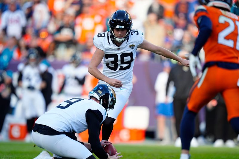 Dec 21, 2025; Denver, Colorado, USA; Jacksonville Jaguars kicker Cam Little (39) kicks a PAT against the Denver Broncos during the first half at Empower Field at Mile High. Mandatory Credit: Ron Chenoy-Imagn Images