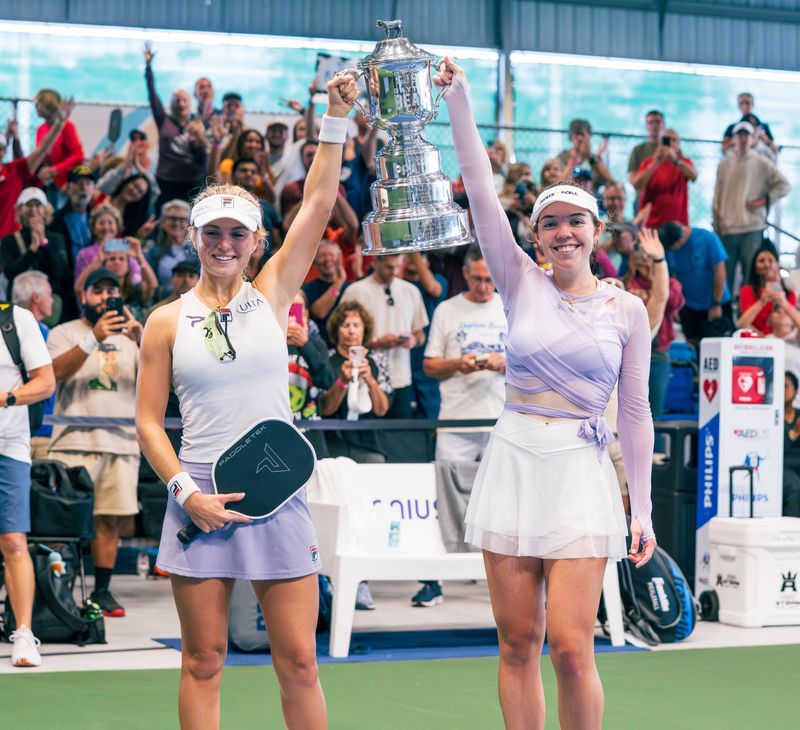 Anna Leigh Waters (left) and Jorja Johnson hoist the championship trophy after their Sunday win in women's doubles at the PPA Tour's Daytona Beach Open.