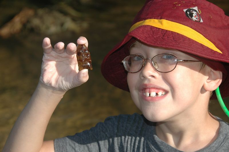The author in 2006 holding a freshly discovered spearpoint on the Chipola River. The artifact dates to about 12,000 years ago from the Suwanee culture. it was thrown back into the river due to Florida’s felony artifact law - never to be found again.
