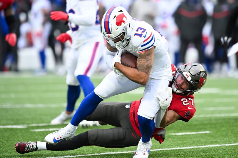 Nov 16, 2025; Orchard Park, New York, USA; Buffalo Bills wide receiver Gabe Davis (13) is brought down by Tampa Bay Buccaneers cornerback Zyon McCollum (27) during the first quarter of the game at Highmark Stadium. Mandatory Credit: Mark Konezny-Imagn Images