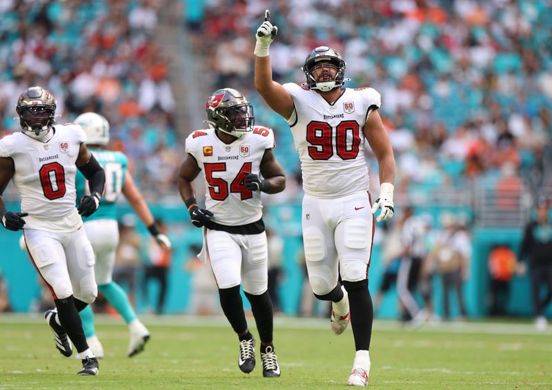 Dec 28, 2025; Miami Gardens, Florida, USA; Tampa Bay Buccaneers defensive end Logan Hall (90) reacts after sacking Miami Dolphins quarterback Quinn Ewers (14, not pictured) during the second quarter at Hard Rock Stadium. Mandatory Credit: Nathan Ray Seebeck-Imagn Images