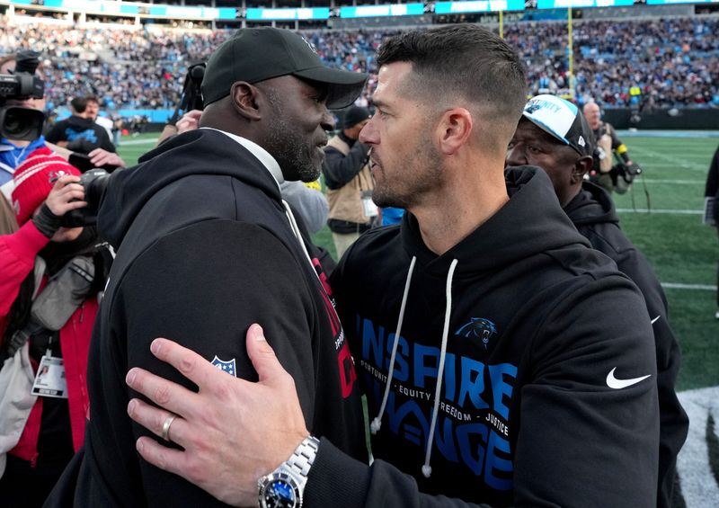 Dec 21, 2025; Charlotte, North Carolina, USA; Carolina Panthers head coach Dave Canales greets Tampa Bay Buccaneers head coach Todd Bowles after a game at Bank of America Stadium. Mandatory Credit: Bob Donnan-Imagn Images