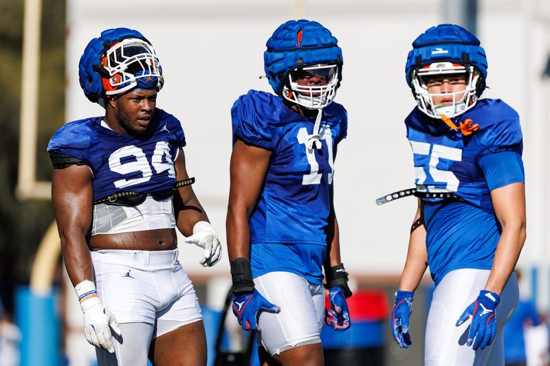Florida Gators edge Tyreak Sapp (94), Florida Gators edge LJ McCray (11) and Florida Gators edge Charles Emanuel III (55) look on during spring football practice at Heavener Football Complex at the University of Florida in Gainesville, FL on Tuesday, March 11, 2025. [Matt Pendleton/Gainesville Sun]
