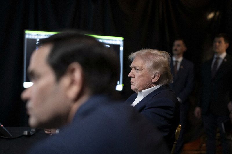 A photograph posted by U.S. President Donald Trump on his Truth Social account shows him sitting next to U.S. Secretary of State Marco Rubio as they watch the U.S. military operation in Venezuela from Trump's Mar a Lago resort, in Palm Beach, Florida, January 3, 2026.