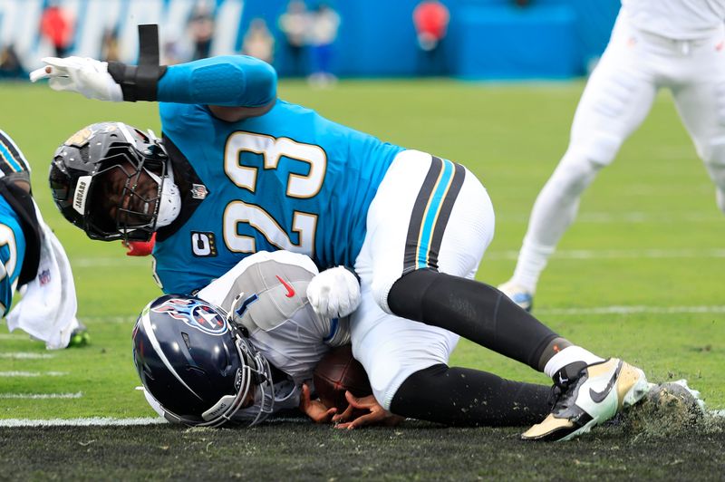 Jacksonville Jaguars linebacker Foye Oluokun tackles Tennessee Titans quarterback Cam Ward as Ward scores a touchdown in the first quarter of their game on Jan. 4 at EverBank Stadium in Jacksonville. Ward left the game with an injured shoulder.