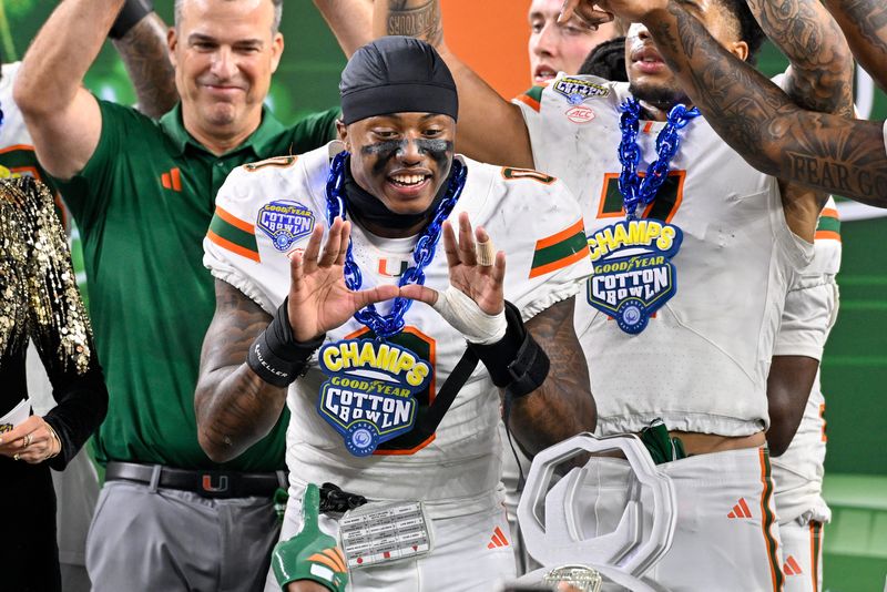 Dec 31, 2025; Arlington, TX, USA; Miami Hurricanes defensive back Keionte Scott (0) celebrates after the 2025 Cotton Bowl and quarterfinal game of the College Football Playoff at AT&T Stadium. Mandatory Credit: Jerome Miron-Imagn Images