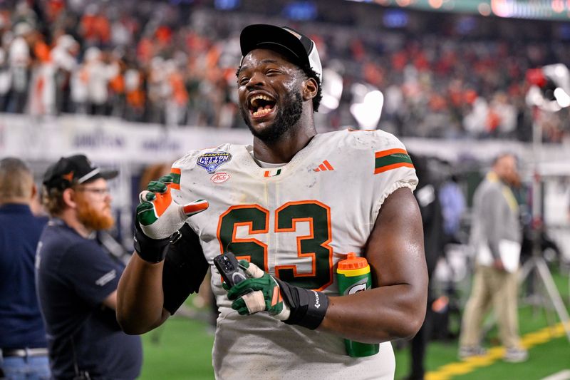 Dec 31, 2025; Arlington, TX, USA; Miami Hurricanes offensive lineman Samson Okunlola (63) walks off the field after the 2025 Cotton Bowl and quarterfinal game of the College Football Playoff at AT&T Stadium. Mandatory Credit: Jerome Miron-Imagn Images