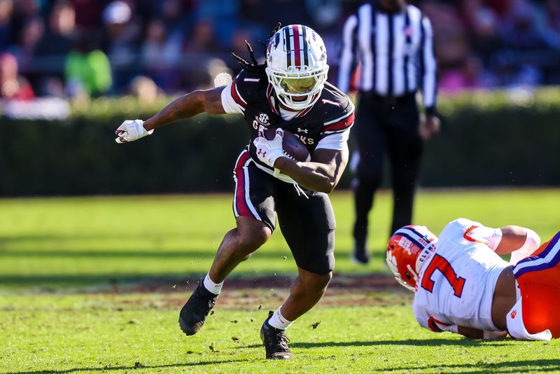 Nov 29, 2025; Columbia, South Carolina, USA; South Carolina Gamecocks running back Rahsul Faison (1) rushes against the Clemson Tigers in the third quarter at Williams-Brice Stadium. Mandatory Credit: Jeff Blake-Imagn Images