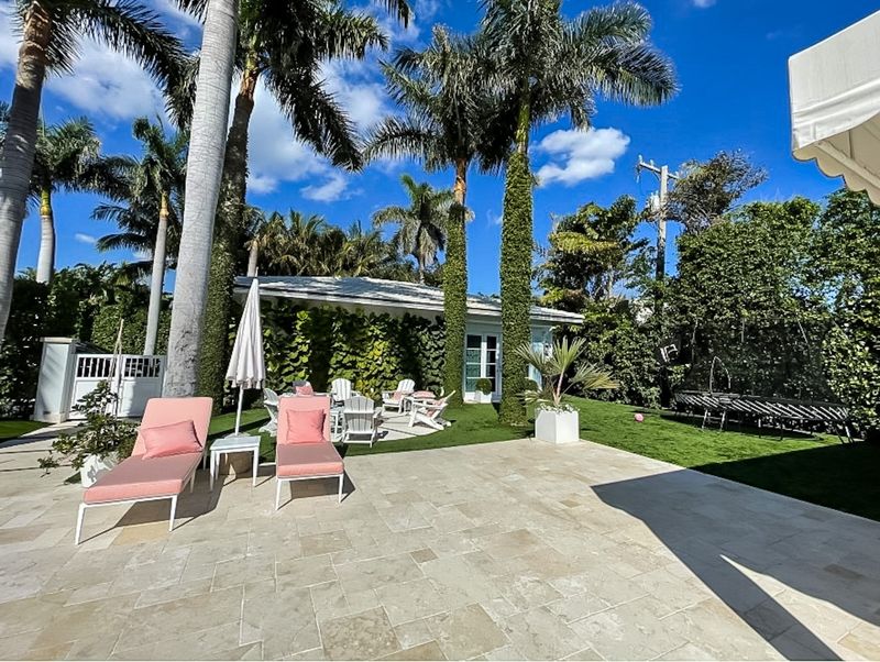 A house at 241 El Dorado Lane in Palm Beach has racked up nearly $80,000 in code-violation fines related to the installation of fake grass on its lawn area. The property also has an extensive patio.