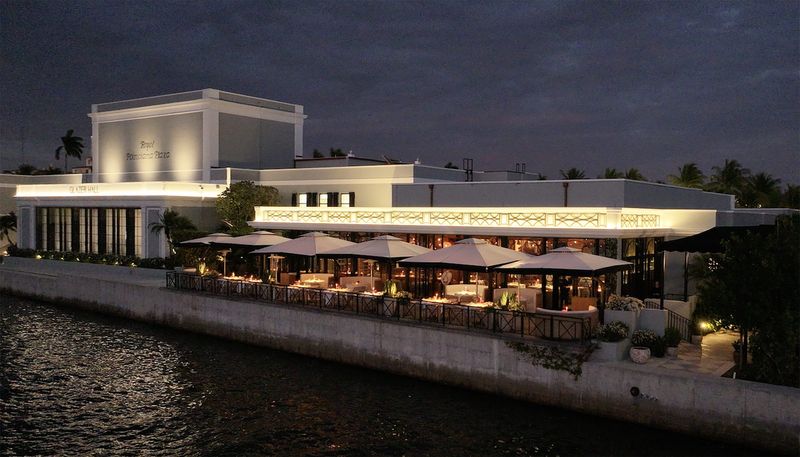 Dining tables with umbrellas stand on the lakefront terrace of the new Tutto Mare restaurant, just south of Glazer Hall in Palm Beach's Royal Poinciana Plaza. The restaurant opened Jan. 3.