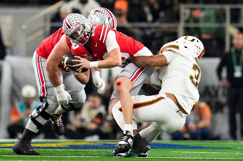Miami Hurricanes defensive lineman Akheem Mesidor (3) hits Ohio State Buckeyes quarterback Julian Sayin (10) during the Cotton Bowl at AT&T Stadium in Arlington, Texas for the College Football Playoff quarterfinal game on Dec. 31, 2025.