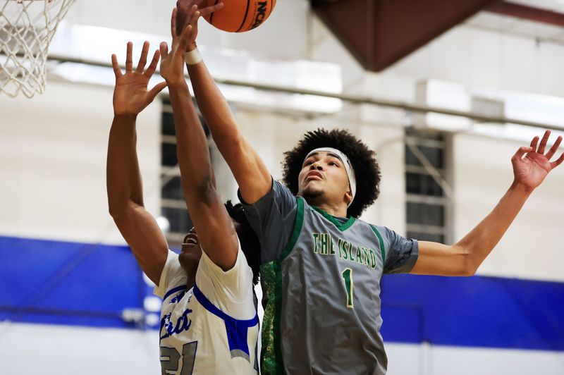 Fleming Island's Carson Crawford (1) grabs a rebound against Impact Christian in a January game.