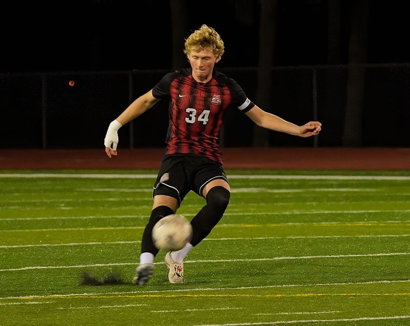 New Smyrna Beach’s Gabe Glatt (34) kicks the ball down the field against Spruce Creek during the boys Five Star Conference Tournament at New Smyrna Beach Sports Complex, Friday, Jan. 9, 2026.