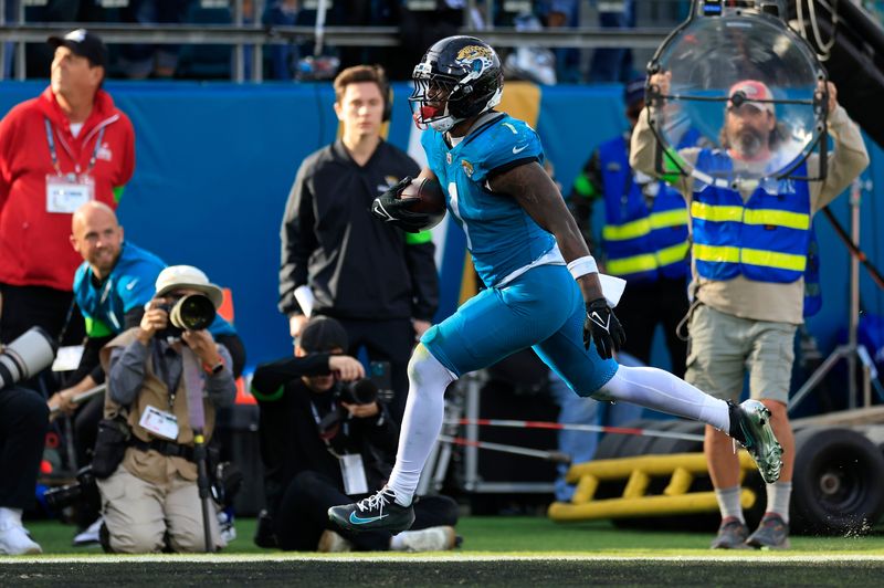 Jacksonville Jaguars running back Travis Etienne Jr. (1) scores a touchdown during the fourth quarter of an NFL football AFC Wild Card playoff matchup, Sunday, Jan. 11, 2026, in Jacksonville, Fla. The Bills defeated the Jaguars 27-24.