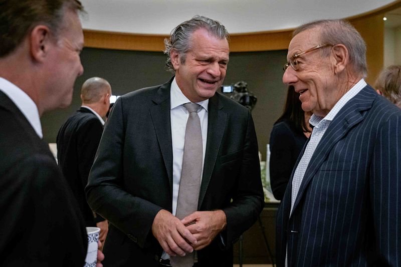 Vanderbilt University Chancellor Daniel Diermeier, center, talks with Stephen Ross, right, at a media event at the Related Ross Experience Center in downtown West Palm Beach, Fla., on January 12, 2026. Diermeier officially announced plans to extend the university's campus to the city. The school will focus on business and engineering tightly integrated with new technologies and artificial intelligence at the new schools, said school representatives.