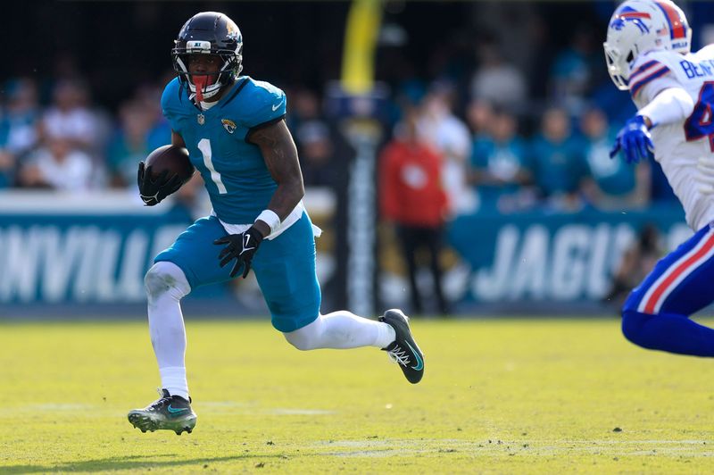Jacksonville Jaguars running back Travis Etienne Jr. (1) rushes for yards during the third quarter of an NFL football AFC Wild Card playoff matchup, Sunday, Jan. 11, 2026, in Jacksonville, Fla. The Bills defeated the Jaguars 27-24. [Corey Perrine/Florida Times-Union]