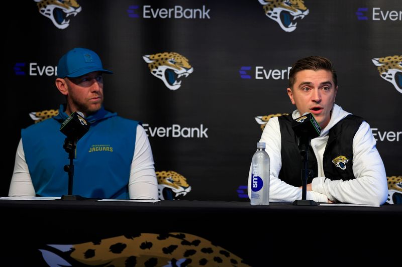 Jacksonville Jaguars general manager James Gladstone, right, speaks as head coach Liam Coen looks on during a press conference at the Miller Electric Center, Wednesday, Jan. 14, 2026, in Jacksonville, Fla.