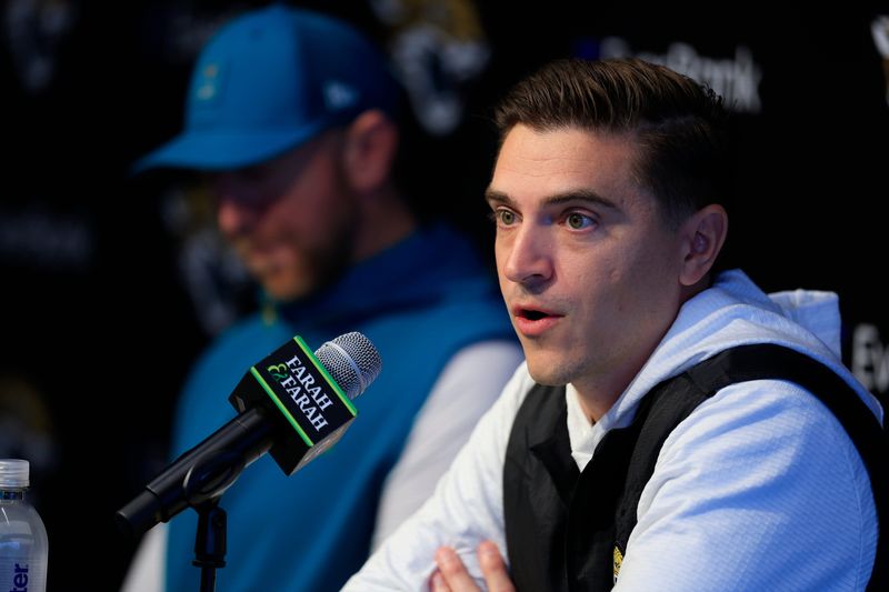 Jacksonville Jaguars general manager James Gladstone speaks during a press conference next to head coach Liam Coen at the Miller Electric Center, Wednesday, Jan. 14, 2026, in Jacksonville, Fla.