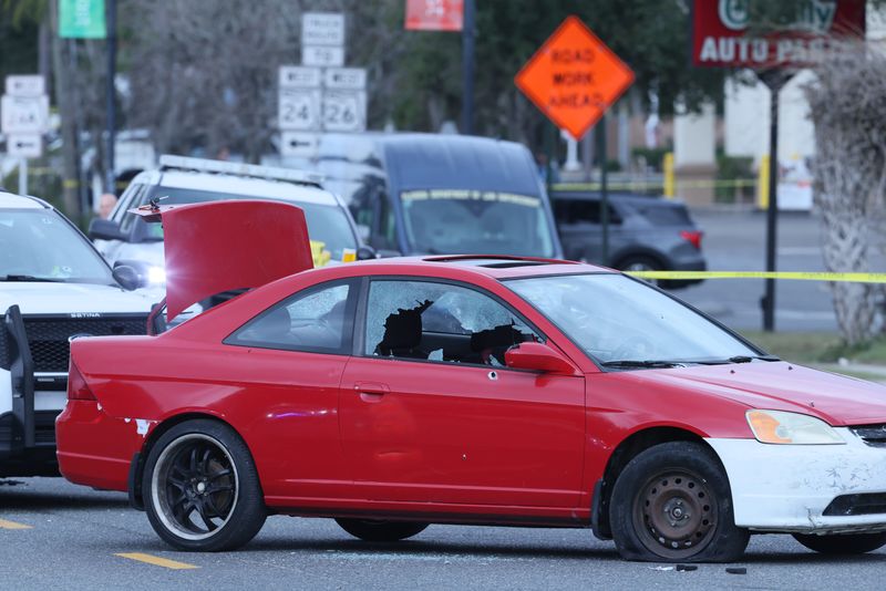 The car belonging to the suspect in the fatal Imeca Lumber & Hardware shooting — who was later shot and killed by a GPD officer — is seen in the middle of East University Avenue on Jan. 26 in Gainesville. Two other officers were shot by the suspect and suffered non-life-threatening injuries.