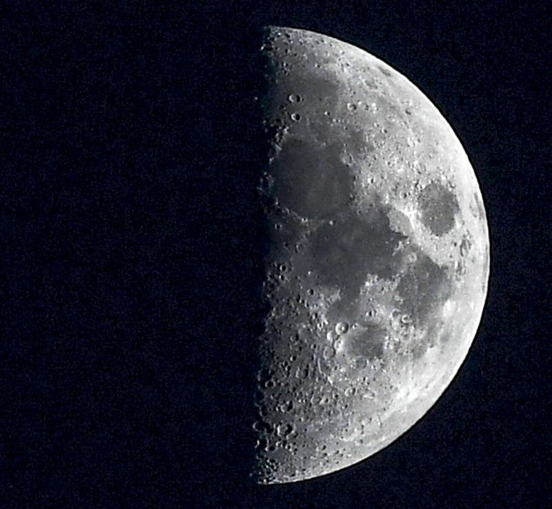 A waxing crescent moon appears near Jupiter and Saturn in December 2020, which were close to each other at the time.