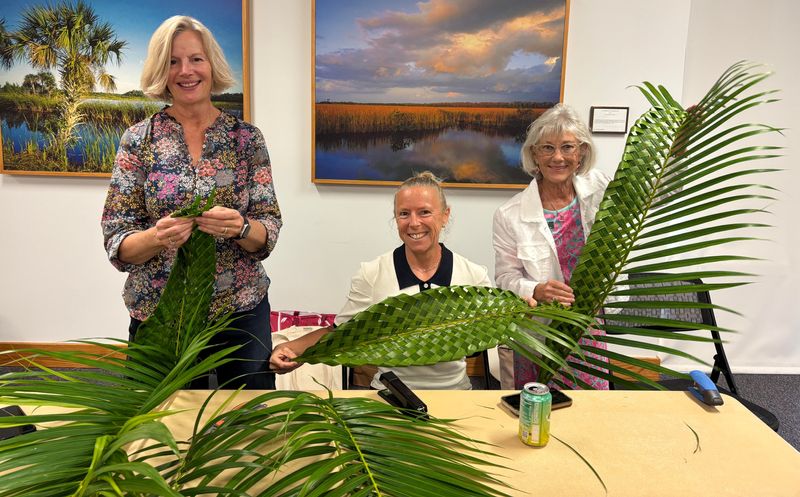 Debra Kuhlman, Annette Kuhn and Margie Bramel with palm leaves.