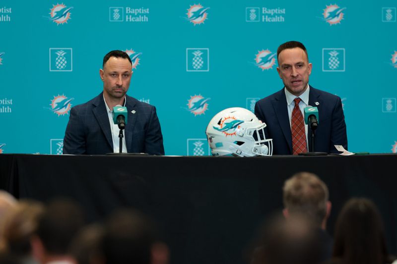 Jan 22, 2026; Miami Gardens, FL, USA; Miami Dolphins head coach Jeff Hafley, right, joined by general manager Jon-Eric Sullivan, left, speak to reporters during their introductory press conference at Baptist Health Training Complex. Mandatory Credit: Sam Navarro-Imagn Images
