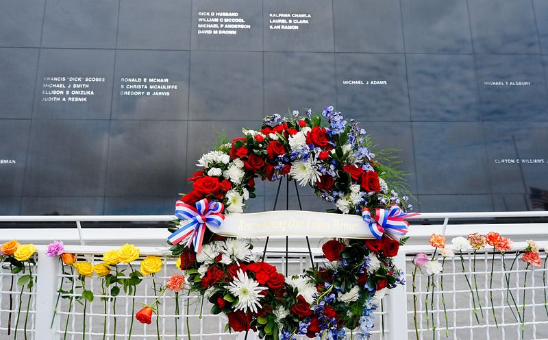 Relatives of those who died in the pursuit of space exploration place flowers in the fence surrounding the Space Mirror January 22, 2026. Today’s Craig Bailey/FLORIDA TODAY via USA TODAY NETWORK