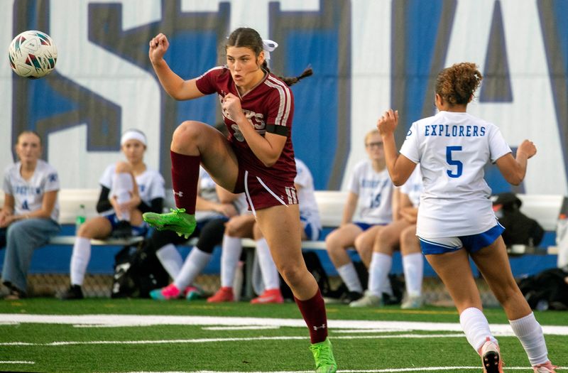 Santa Fe Catholic's Copeland Collany controls the loose ball as Ridgeview Global Studies' Marwa Zaafane closes in. ROY FUOCO/THE LEDGER