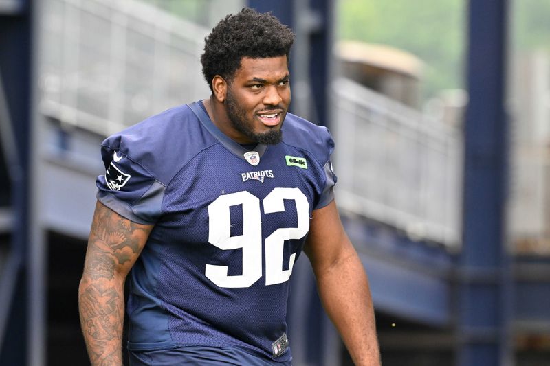 Jun 9, 2025; Foxborough, MA, USA; New England Patriots defensive tackle Joshua Farmer (92) walks to the practice fields at Gillette Stadium. Mandatory Credit: Eric Canha-Imagn Images
