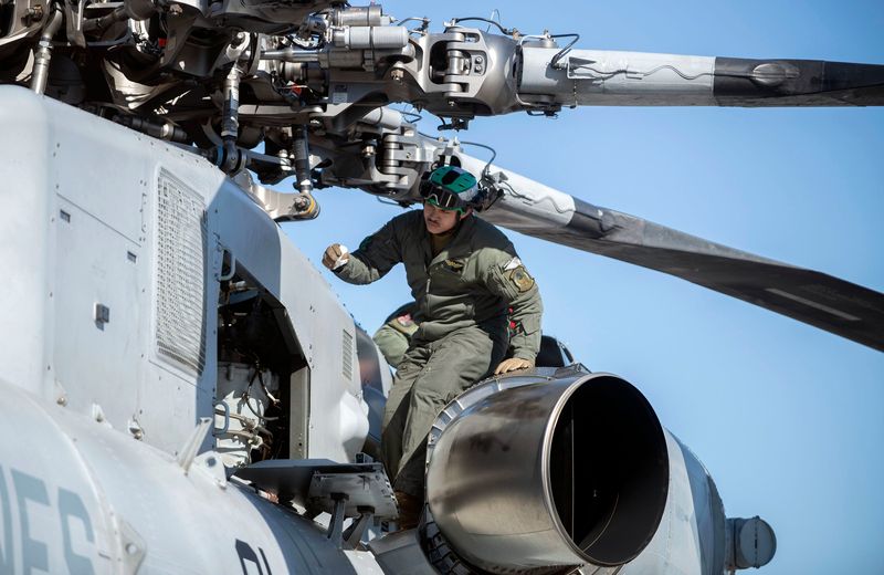 Marine Sgt. R.L. Hill performs routine maintenance on an H-53K King Stallion while visiting NAS Whiting Field in Milton during the installation's annual Fleet Fly-in event.