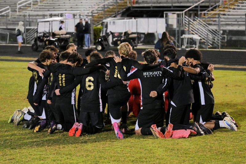 Olympic Heights' soccer team commemorates their accomplishment after a district championship win against Seminole Ridge on Jan. 27, 2026.