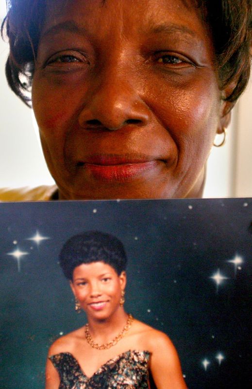 In this 2006 photo, Laurvetta Grimsley-McLawrence holds a photo of her daughter Ali Gilmore who disappeared from her home Feb. 3, 2006.