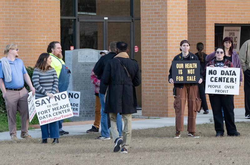 Residents show their opposition to a proposed data center before the start of a town hall at Fort Meade Middle-Senior High School on Jan. 29.