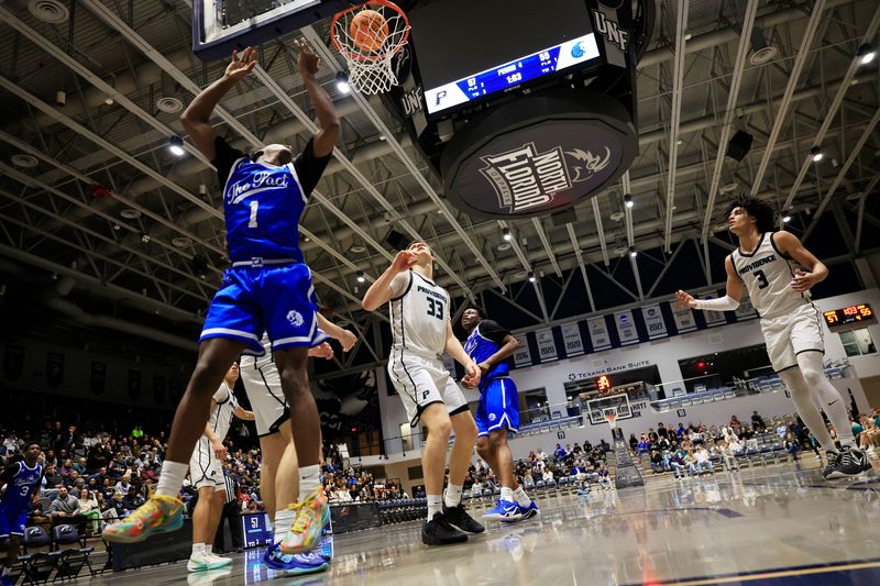 Impact Christian's Ronald Clark (1) ties the game at 57 apiece as Providence's Nolan Nelson (33) and Marvin Christie (3) look on during the fourth quarter at UNF Arena on Jan. 30. Both Impact and Providence are among 56 high school basketball teams that will be playing at UNF Arena from March 5-15.