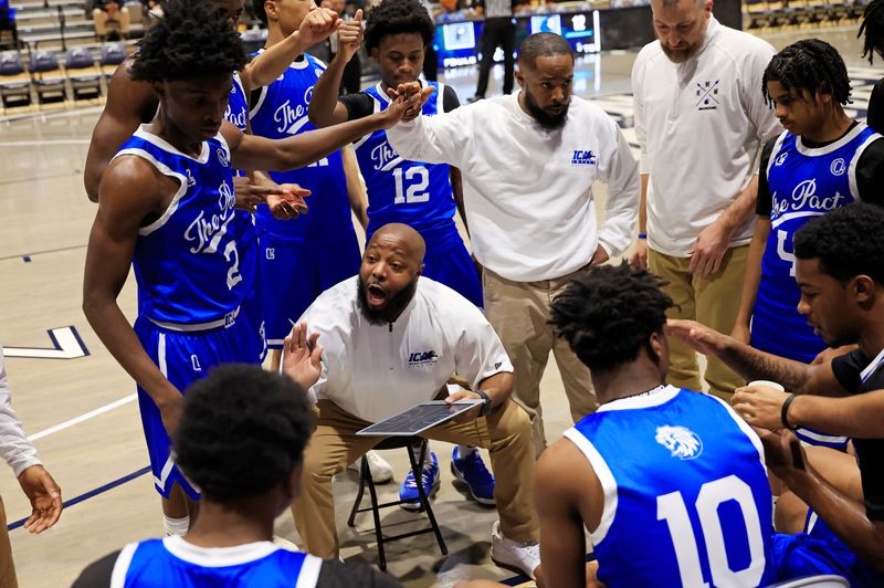 Impact Christian head coach Ben Jones coaches during a timeout during the second quarter of a high school basketball matchup at UNF Arena against Providence.