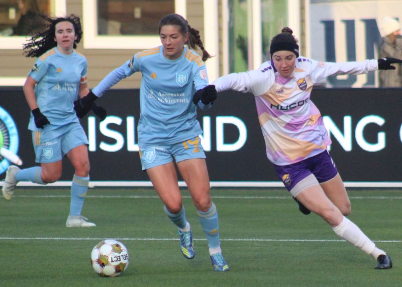 Sporting Jax midfielder Ashlyn Puerta (19) dribbles into the box as Carolina Ascent fullback Brianna Martinez (2) defends during a Gainbridge Super League women's soccer match on Jan. 31, 2026. [Clayton Freeman/Florida Times-Union]