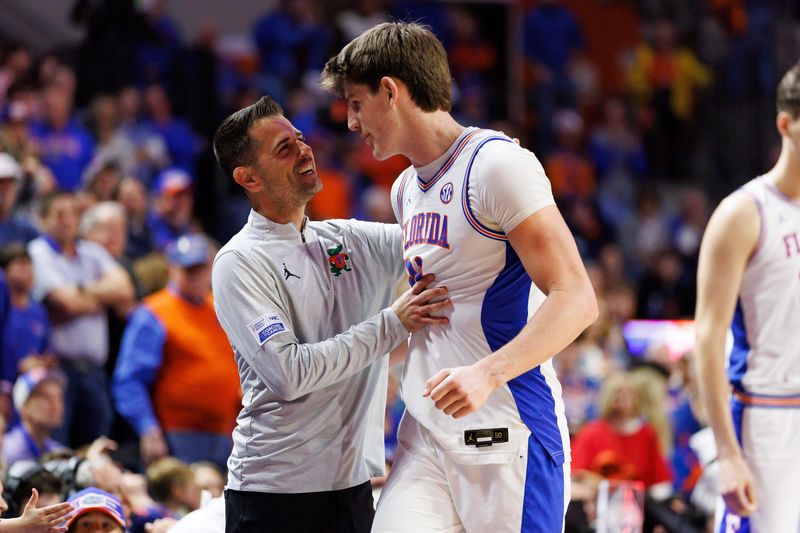 Feb 1, 2026; Gainesville, Florida, USA; Florida Gators head coach Todd Golden embraces Florida Gators forward Alex Condon (21) against the Alabama Crimson Tide during the second half at Exactech Arena at the Stephen C. O'Connell Center. Mandatory Credit: Matt Pendleton-Imagn Images
