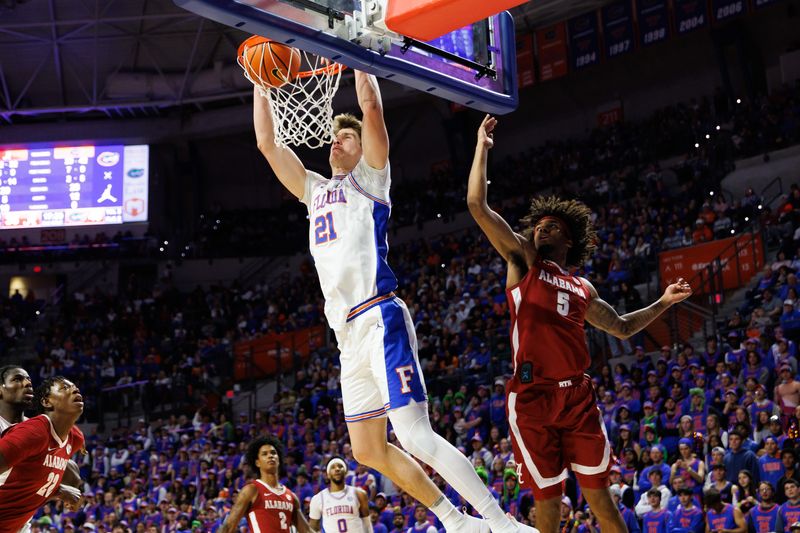 Feb 1, 2026; Gainesville, Florida, USA; Florida Gators forward Alex Condon (21) dunks the ball over Alabama Crimson Tide forward Amari Allen (5) during the second half at Exactech Arena at the Stephen C. O'Connell Center. Mandatory Credit: Matt Pendleton-Imagn Images