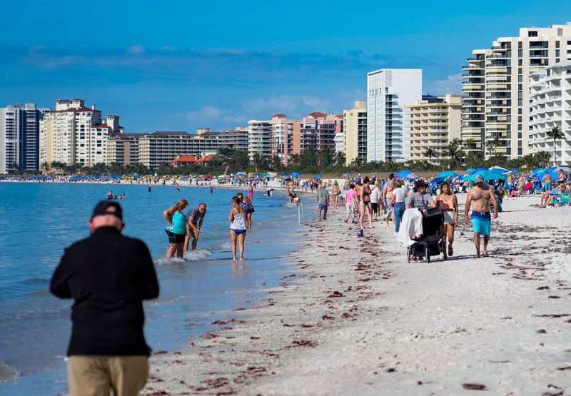 Hundreds of people enjoy the beach as temps hit the mid 70s after a cold snap at the southern beach access on Marco Island, Fla., on Wednesday, Feb. 4, 2026.