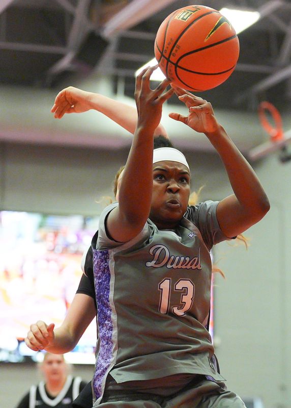 Edward Waters Tigers forward Shcira Fowles (13) comes up with a rebound over Spring Hill Badgers center Ella Vallas (14) in the first period. Edward Waters hosted Spring Hill College Thursday February 5, 2026 at the Adams-Jenkins Community Sports & Music Complex in Jacksonville, Fla. The Edward Waters women's basketball team is leading the SIAC conference and is among the national leaders in defense. The Tigers defeated the Badgers 66-32. [Doug Engle/Florida Times-Union]