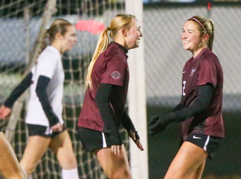 Niceville Michelle Melancon, left, and Delaney Diehl, right, celebrate Melancon’s early goal during the Niceville Navarre girls regional quarterfinal soccer match at Niceville.