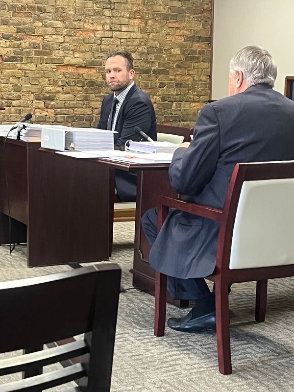 Dr. Ben Brown waits with his lawyer Bruce Lamb during an administrative hearing over his medical license.