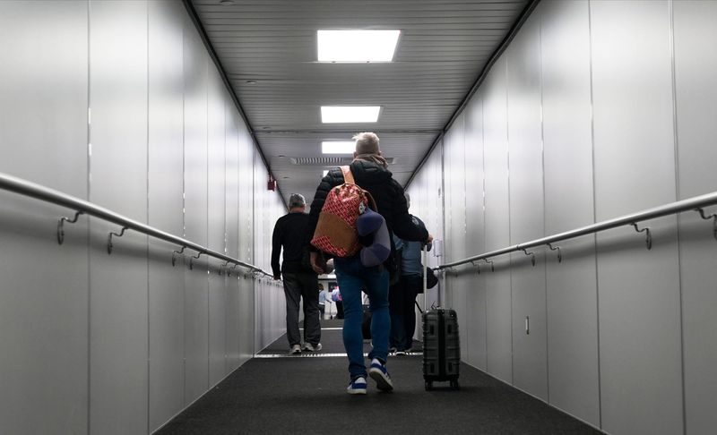 Travelers move about Southwest Florida International Airport Friday, February 6, 2026. The airport was unveiling its new temporary checkpoint at Concourse C as part of the work for the Terminal Expansion Project Phase 1.