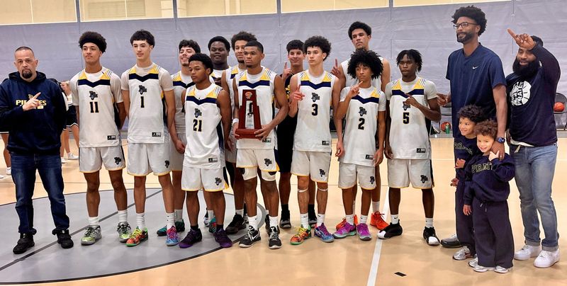 The Tradition Prep boys basketball team poses with the championship trophy after defeating Avon Park, 71-31, in the Class 3A-District 9 championship Saturday afternoon at the Havert L. Fenn Center in Fort Pierce.